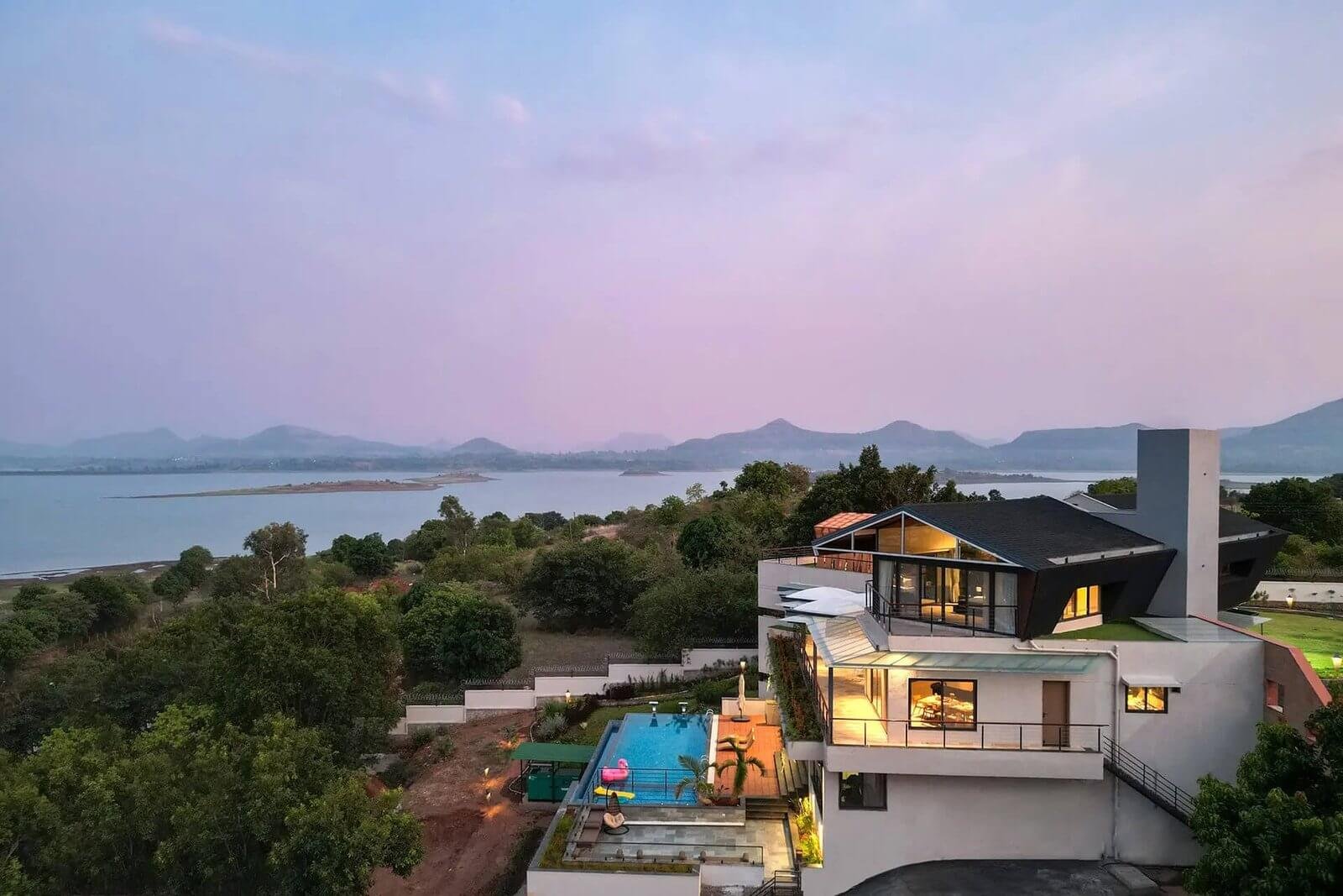 LAKEVIEW HERO – Twilight shot. Infinity pool reflecting the sky, Vaitarna Lake behind, Sahyadri